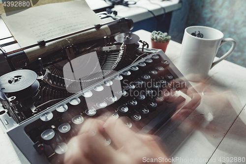 Image of Writer typing with retro writing machine.