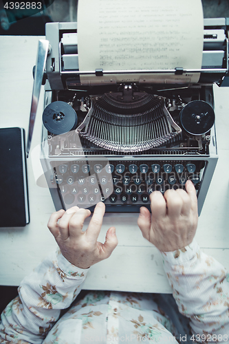 Image of Writer typing with retro writing machine.