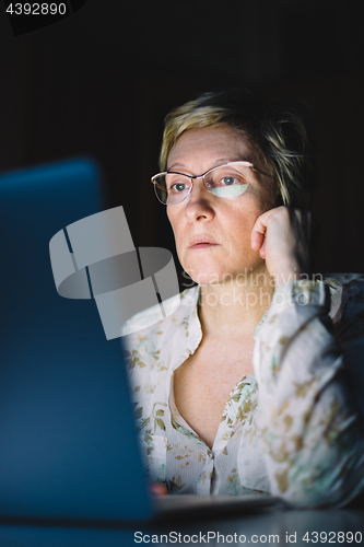 Image of Middle-aged woman working on laptop
