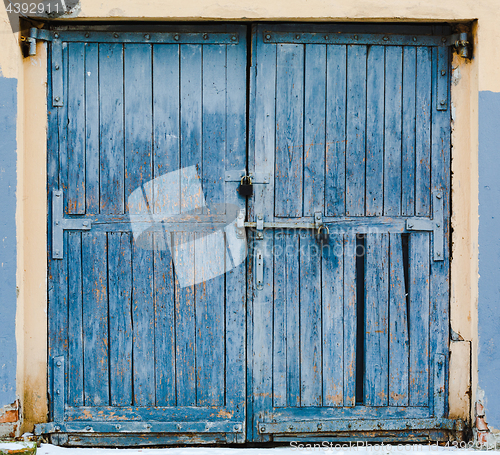 Image of Old large wooden doors painted in blue