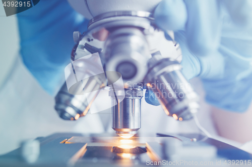 Image of Close up of examining of test sample under the microscope