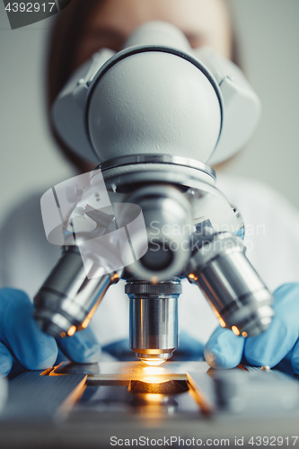 Image of Close up of examining of test sample under the microscope