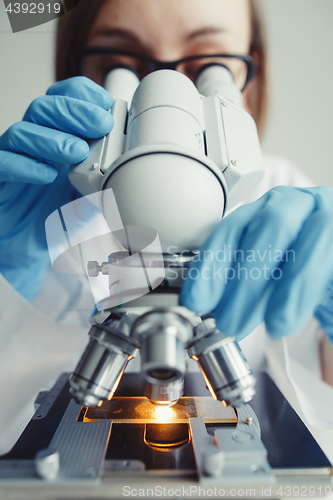 Image of Close up of examining of test sample under the microscope