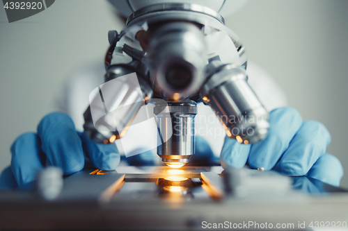 Image of Close up of examining of test sample under the microscope