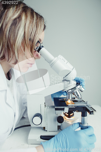 Image of Close up of examining of test sample under the microscope