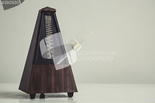 Image of Color shot of a vintage metronome