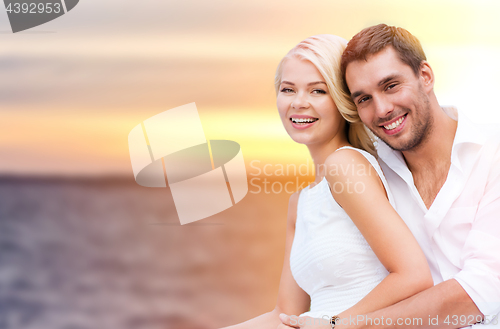 Image of happy couple hugging over sea background