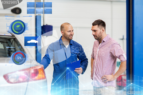 Image of auto mechanic with clipboard and man at car shop