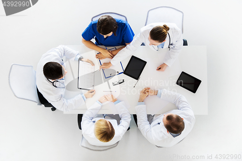 Image of doctors with cardiograms and tablet pc at hospital