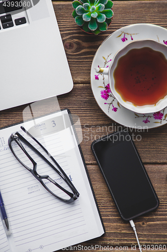 Image of Working place with laptop on wooden table