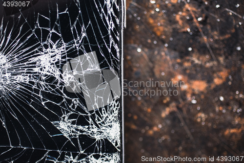 Image of Big modern smartphone with broken screen debris