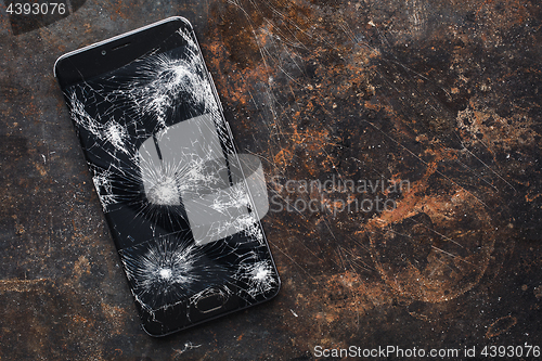 Image of Big modern smartphone with broken screen debris