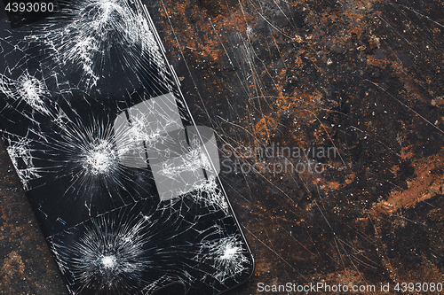 Image of Big modern smartphone with broken screen debris