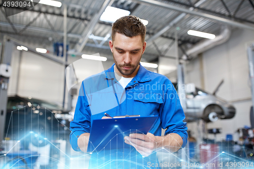 Image of auto mechanic man with clipboard at car workshop