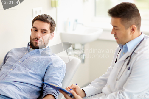 Image of doctor and man with health problem at hospital