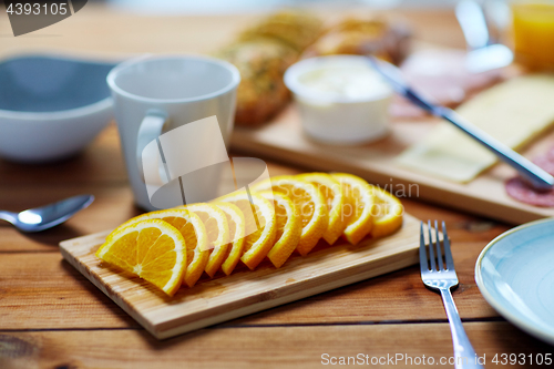 Image of sliced orange and other food on wooden table