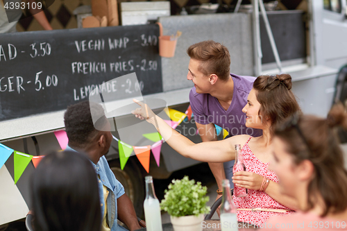 Image of happy customers or friends at food truck