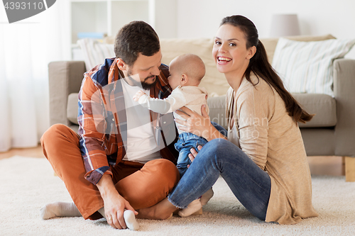 Image of happy family with baby having fun at home