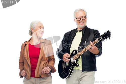 Image of happy senior couple with electric guitar