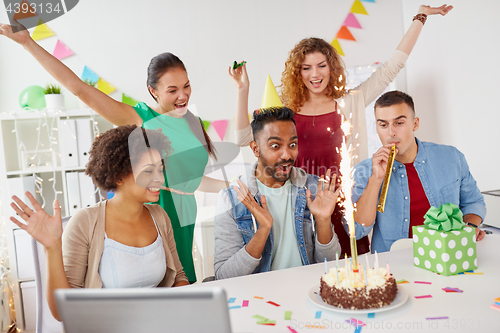 Image of office team greeting colleague at birthday party