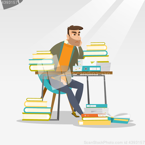 Image of Student sitting at the table with piles of books.