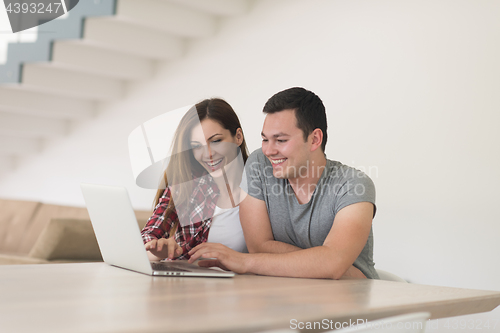 Image of happy young couple buying online