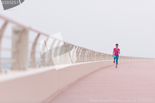 Image of woman busy running on the promenade