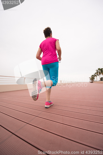 Image of woman busy running on the promenade