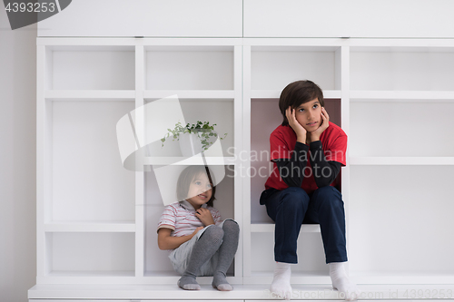 Image of young boys posing on a shelf