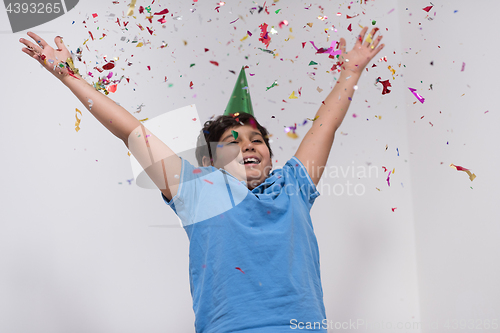 Image of kid blowing confetti