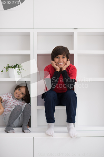 Image of young boys posing on a shelf