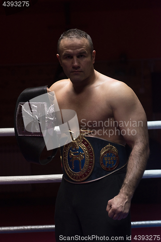 Image of kick boxer with his championship belt