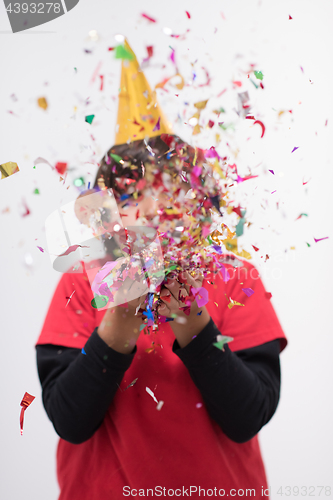 Image of kid blowing confetti