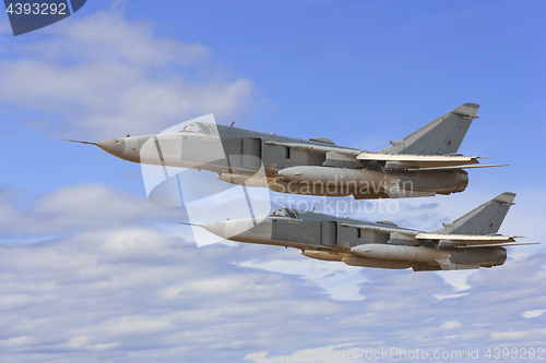 Image of Military jet bomber Su-24 Fencer flying above the clouds