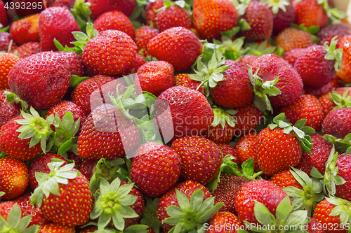 Image of Background of beautiful and juicy strawberries with green leaves