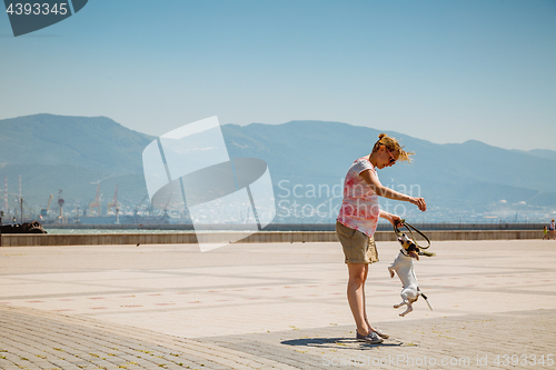 Image of Woman with her dog playing