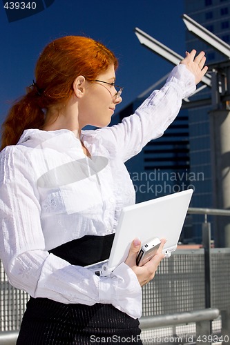 Image of happy businesswoman in the city