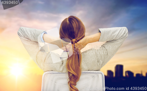 Image of businesswoman sitting on chair from back