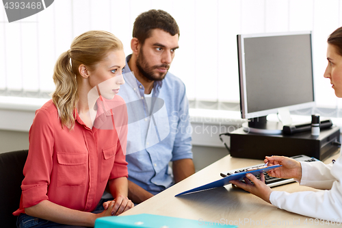 Image of couple visiting doctor at family planning clinic