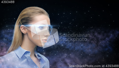 Image of woman in virtual reality glasses over space