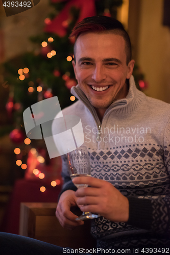 Image of Happy young man with a glass of champagne