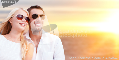 Image of happy couple in sunglasses over sea background