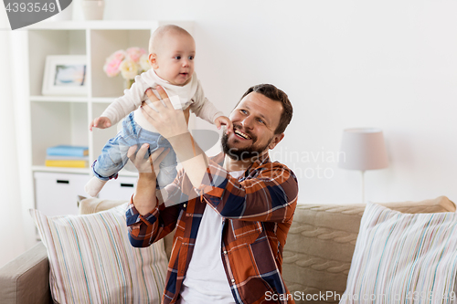 Image of happy father with little baby boy at home