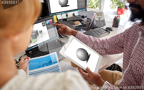 Image of designers with 3d models on laptop and tablet pc