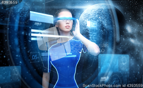 Image of woman in virtual reality glasses over space