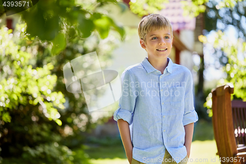 Image of happy smiling boy at summer garden