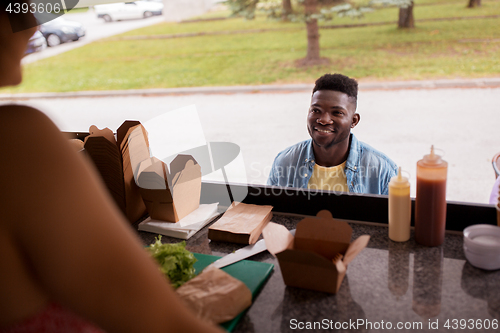 Image of african american man ordering wok at food truck