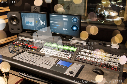 Image of music mixing console at sound recording studio