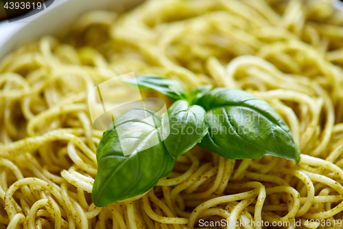 Image of close up of cooked pasta with basil leaves