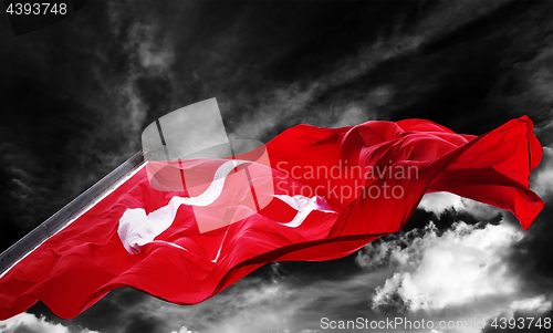 Image of Flag of Turkey waving against black and white sky